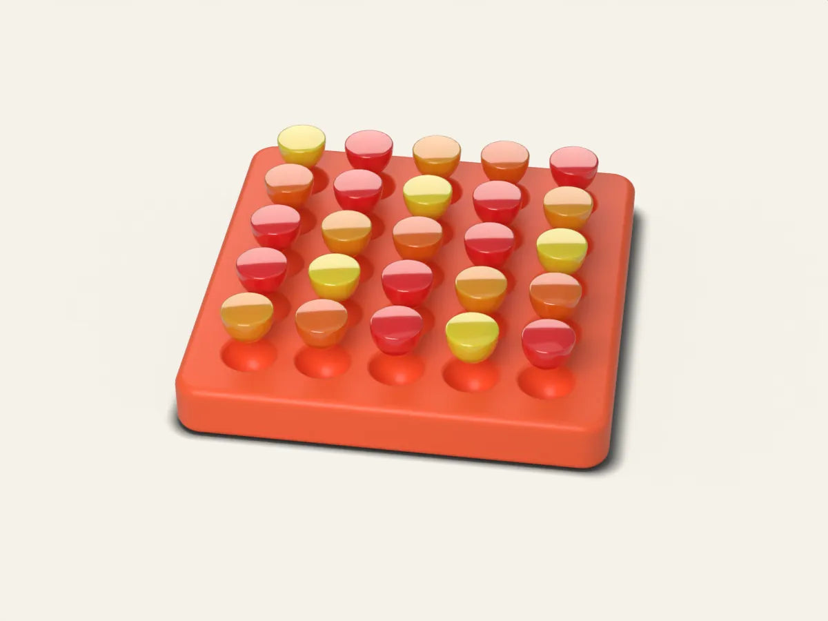 Gummy drops lifting out of a coral silicone tray